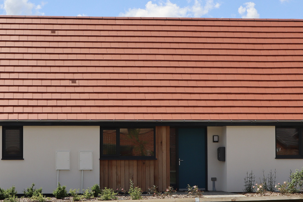Planum Concrete roof tiles finished in Cayenne Red